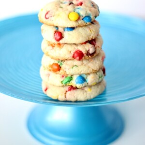 A single stack of Funfetti cookies resting on a large blue cake rack.