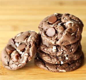 Stack of double chocolate coconut cookies with chocolate chips.