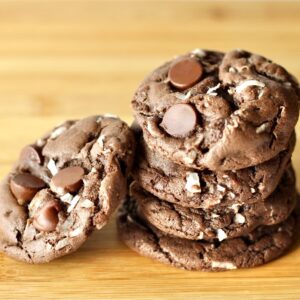 Stack of double chocolate coconut cookies with chocolate chips.