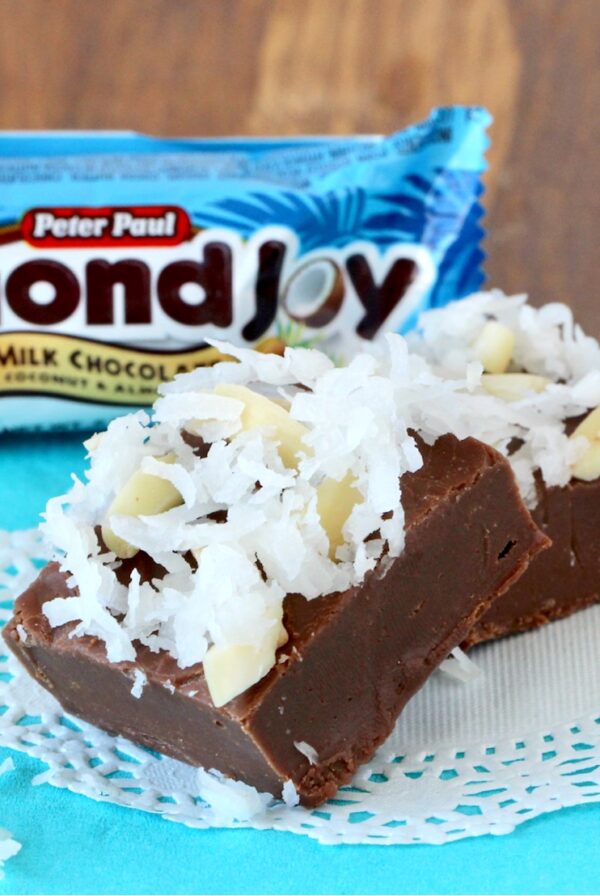 Two pieces of chocolate coconut fudge on doily.