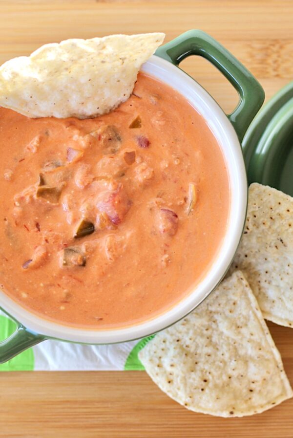 Cream cheese salsa dip in bowl with tortilla chips to the side.