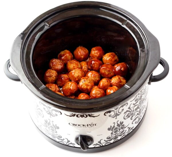 Cooked meatballs in crock pot glazed with honey garlic sauce.