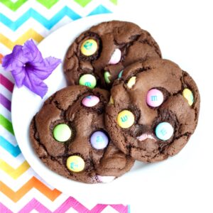 Three chocolate Easter M&M cookies on plate.