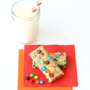 Two granola bars without nuts on napkin with M&M's.
