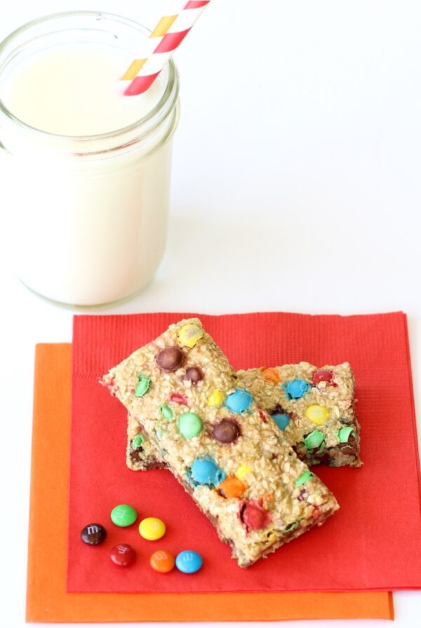 Two granola bars without nuts on napkin with M&M's.