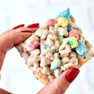 Hand holding Lucky Charms marshmallow krispie treat.