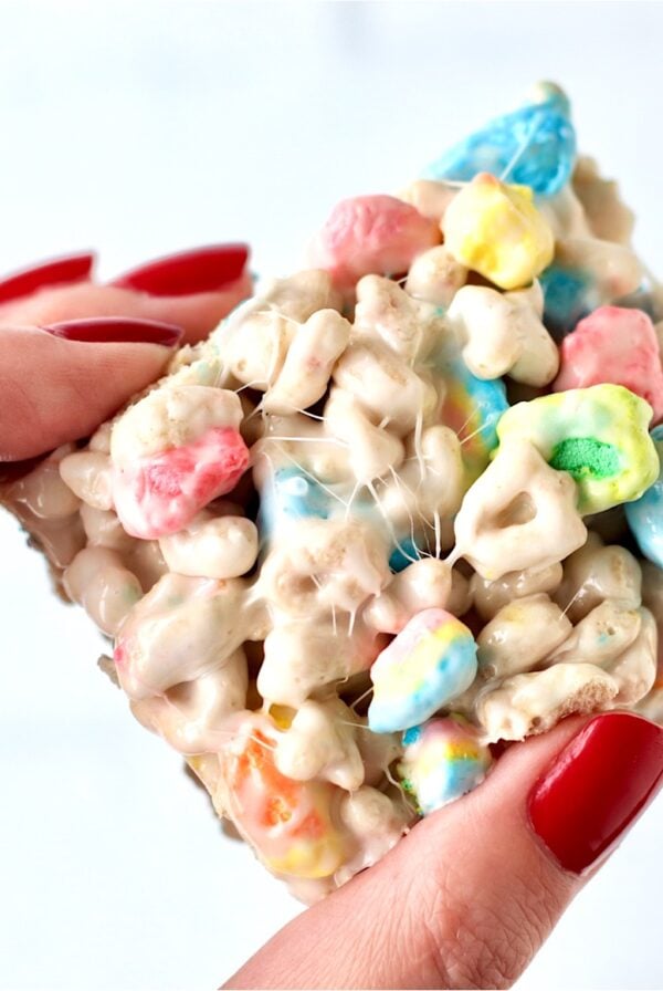 Hand holding Lucky Charms marshmallow krispie treat.