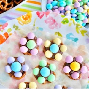 M&M Pretzel flowers on plate with bowls of pretzels and M&Ms to the side.