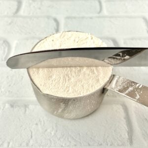 Flour in measuring cup spooned in and leveled off with back of knife.