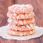 Stack of strawberry cake mix cookies with powdered sugar crinkles.