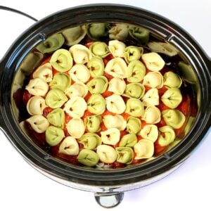 Cheese tortellini with marinara sauce in crockpot.