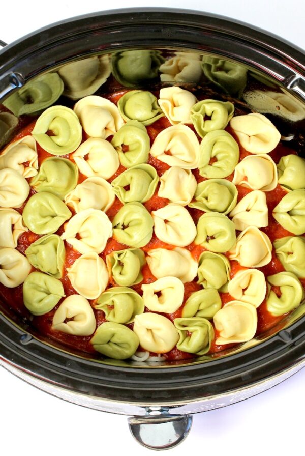 Cheese tortellini with marinara sauce in crockpot.