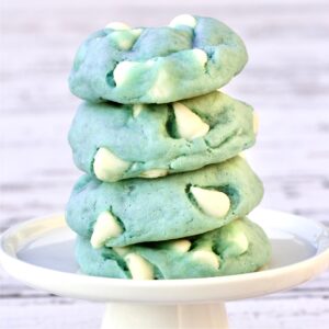 Stack of four winter cookies tinted light blue with white chocolate chips.