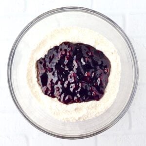 Blueberry pie filling and angel food cake mix powder in large mixing bowl.