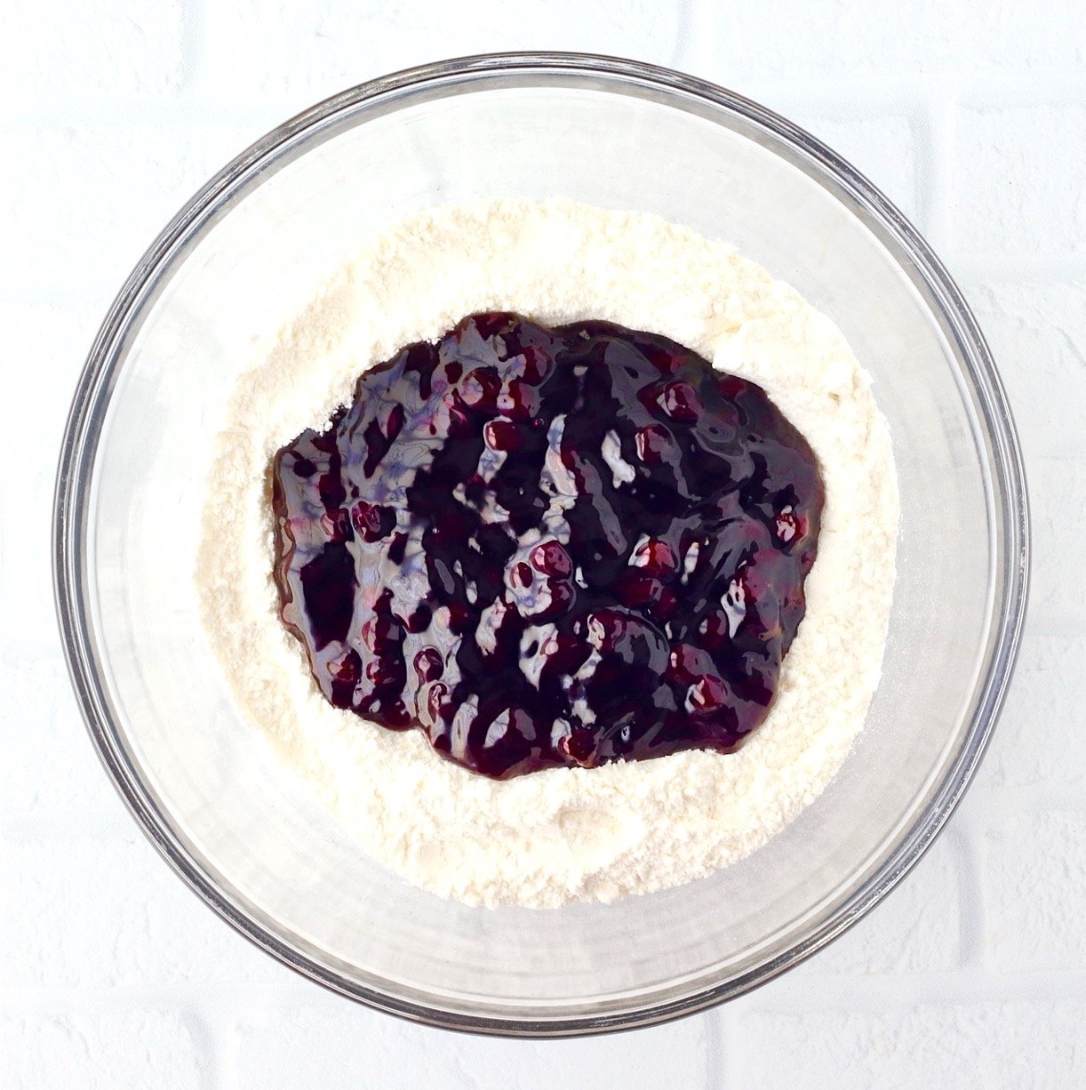Blueberry pie filling and angel food cake mix powder in large mixing bowl.