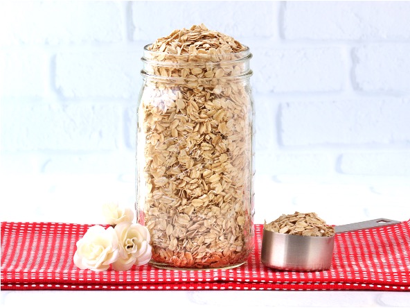 Oats in a large mason jar on a red napkin.