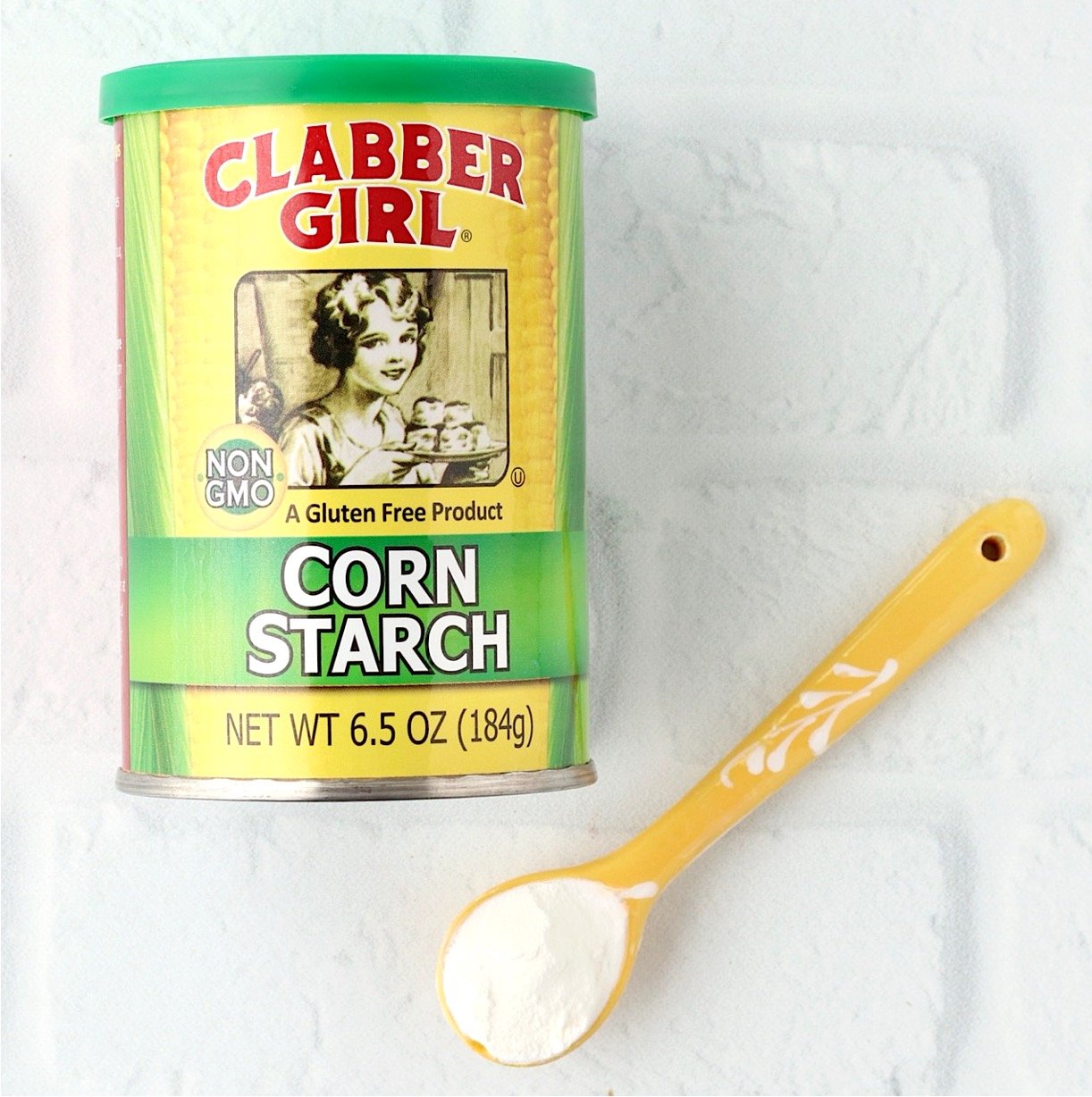 Corn starch can with teaspoon of corn starch to the side.