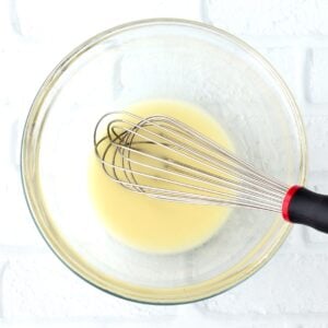Cornstarch water paste in bowl with whisk.
