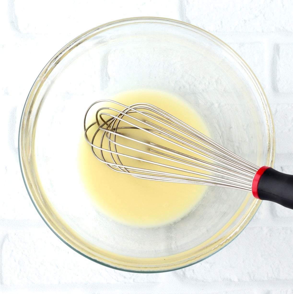 Cornstarch water paste in bowl with whisk.