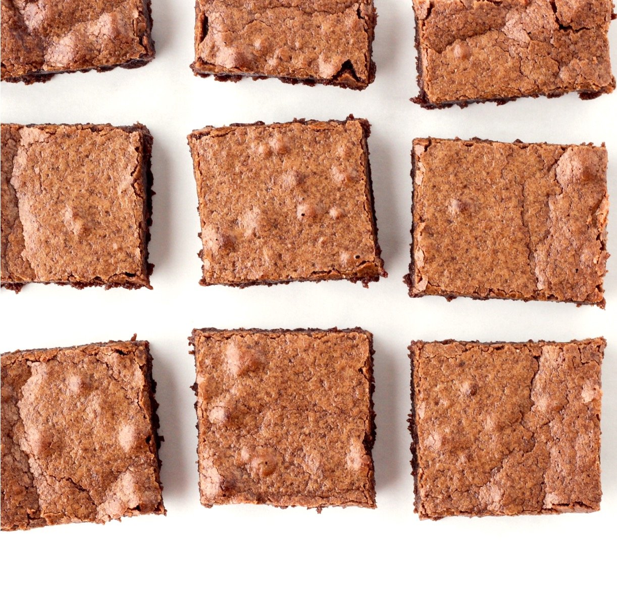 Nine chocolate homemade brownies cut into squares.
