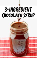 Homemade chocolate syrup being drizzled off spoon into mason jar.