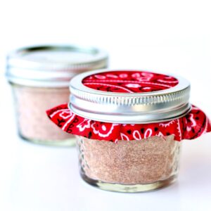 Homemade taco seasoning mix in two small mason jars.