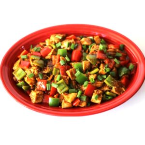 Kung Pao Chicken with bell peppers and green onions on platter.