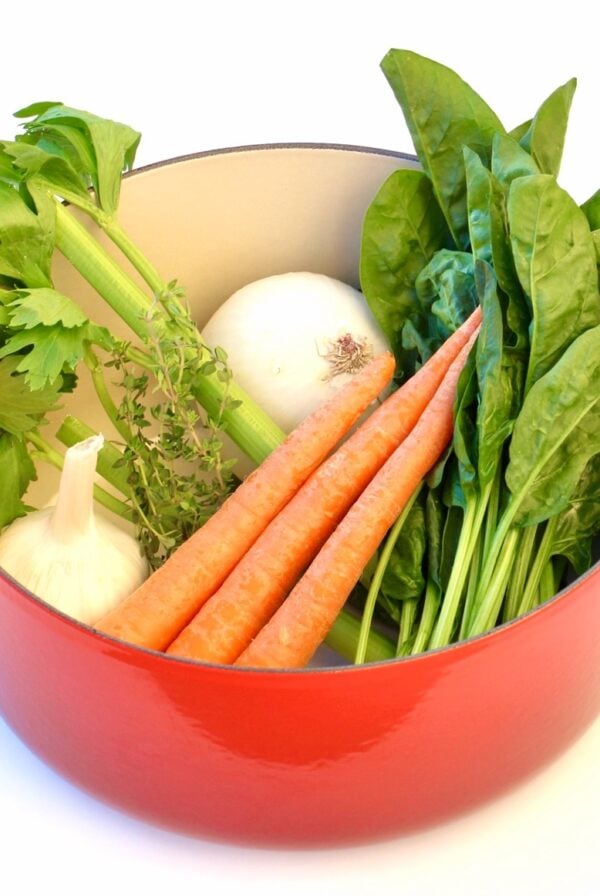 Fresh ingredients for Olive Garden chicken gnocchi soup in dutch oven.
