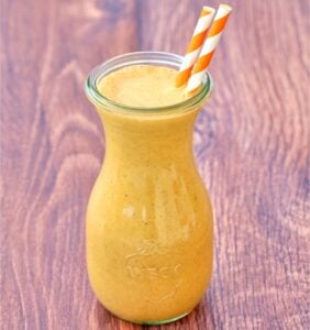 Pumpkin Milkshake in jar with two straws.