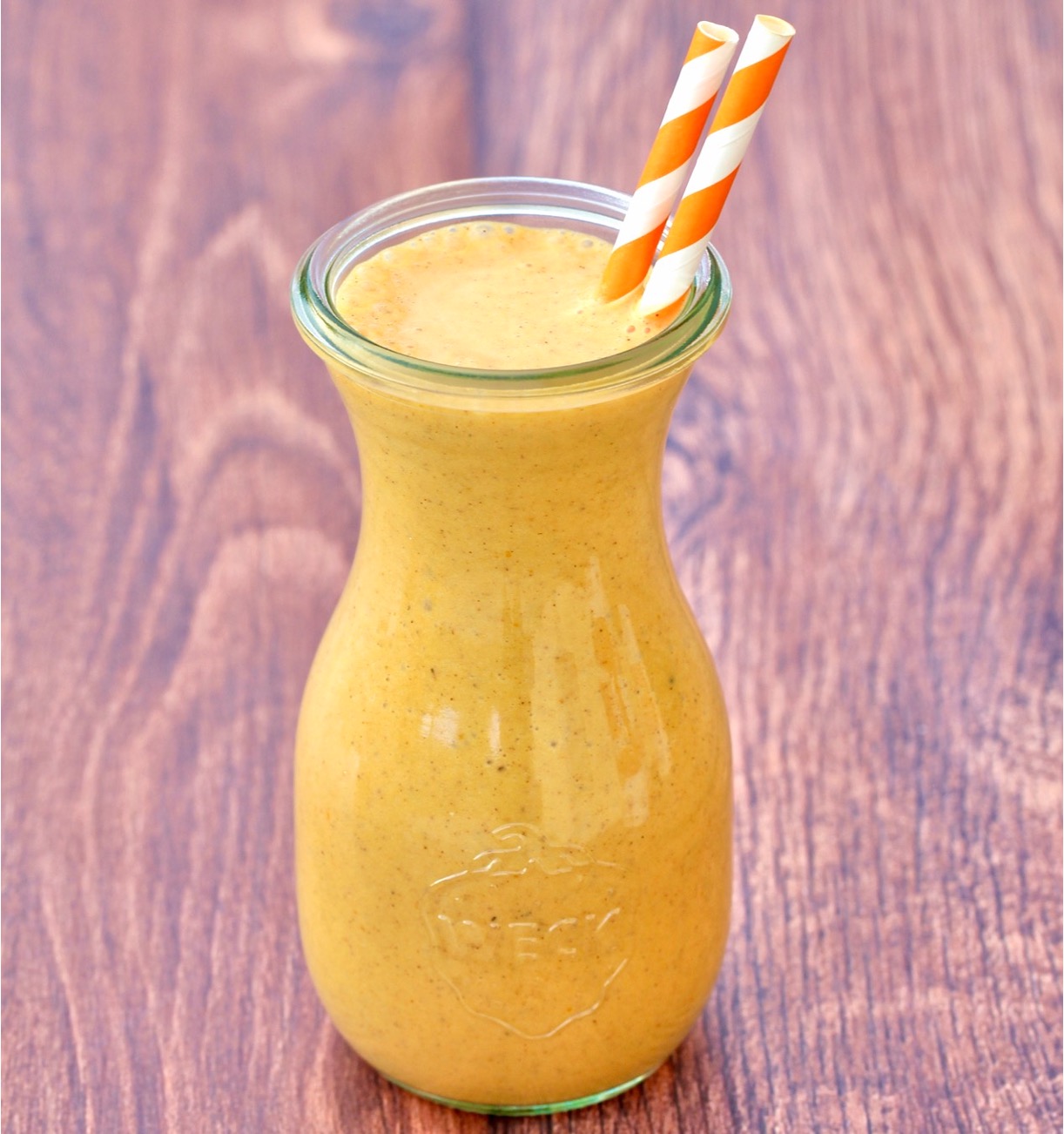 Pumpkin Milkshake in jar with two straws.