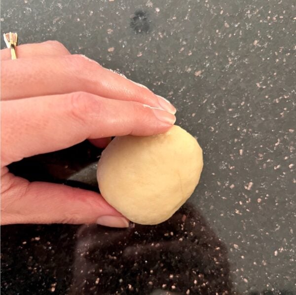 Hand rolling dough into ball.