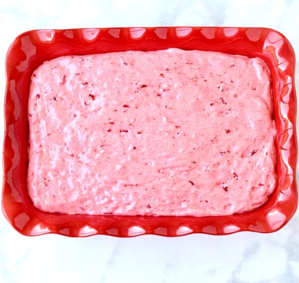 Strawberry angel food cake batter in 9x13 baking dish.