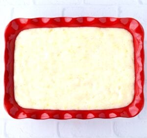 Pineapple angel food cake batter in 9x13 baking dish.