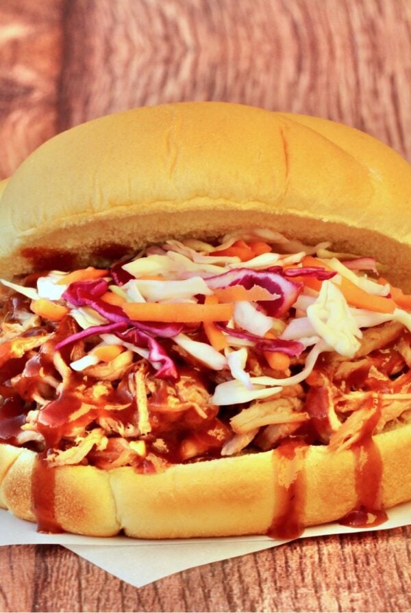 BBQ pulled pork sandwich with coleslaw on hamburger bun.