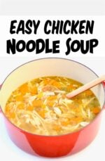 Homemade chicken noodle soup in dutch oven with wooden spoon.