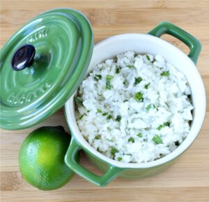 Cilantro lime rice in bowl with lime to the side.