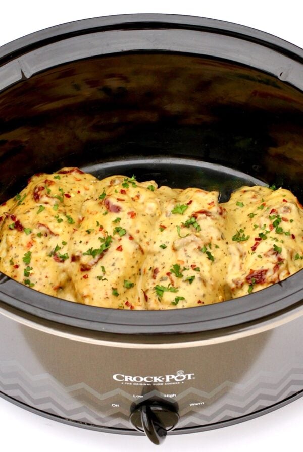 Four pieces of Tuscan Chicken in crock pot.