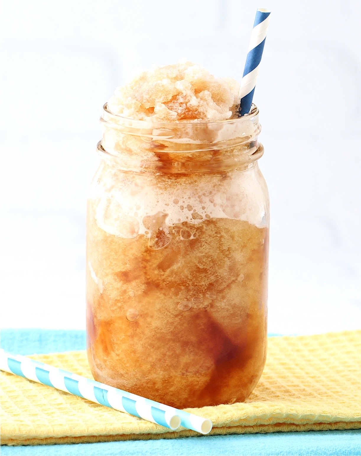 Iced tea slushie in mason jar with straw.