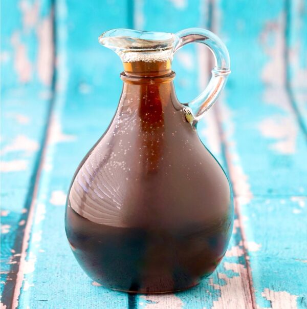 Homemade maple syrup in syrup dispenser.