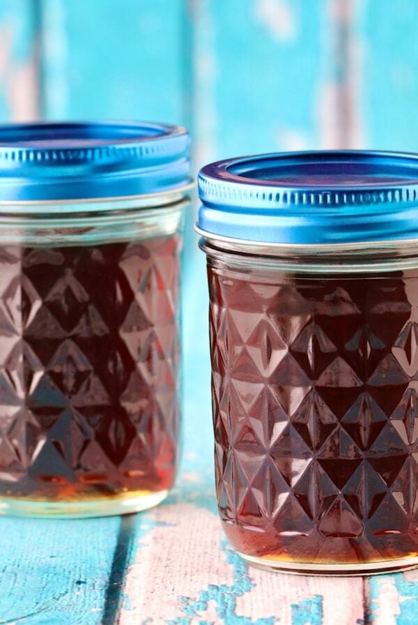 Two mason jars filled with homemade maple syrup.