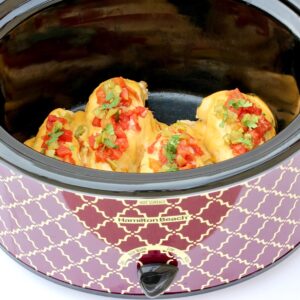 Four pieces of queso chicken in crockpot.