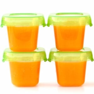 Four small containers of homemade butternut squash baby food puree.