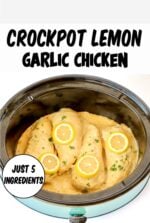 Four pieces of creamy lemon garlic chicken in crockpot with lemon slices and parsley on top.