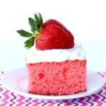 Strawberry Greek Yogurt Cake with cool whip and a strawberry on top.