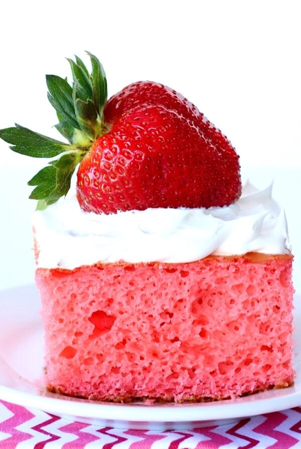 Strawberry Greek Yogurt Cake with cool whip and a strawberry on top.