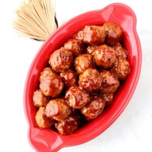 Barbecue meatballs in dish with toothpicks to the side.
