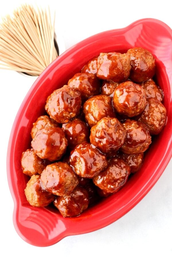 Barbecue meatballs in dish with toothpicks to the side.