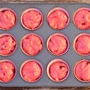 Strawberry cupcakes batter in cupcake liners, in muffin pan.