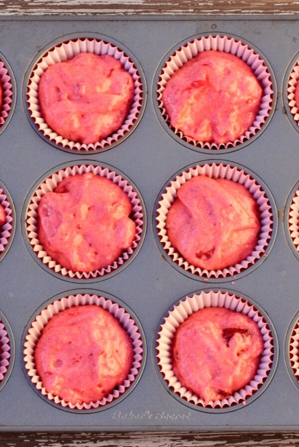 Strawberry cupcakes batter in cupcake liners, in muffin pan.