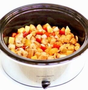 Sweet Chili Chicken with pineapple, onions, and bell peppers in crockpot.
